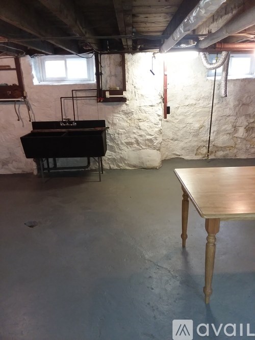 A room with a piano and a table.