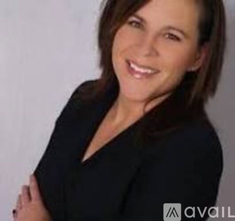 A woman with dark hair wearing a black top.