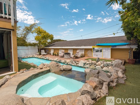 A backyard with a pool and a house.