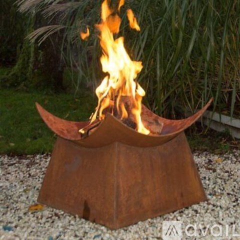 A fire is burning in a metal fire pit.