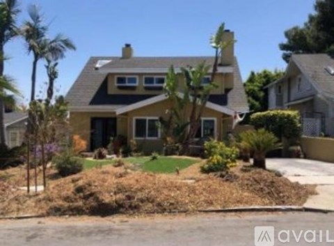 A house with a front yard and a driveway.