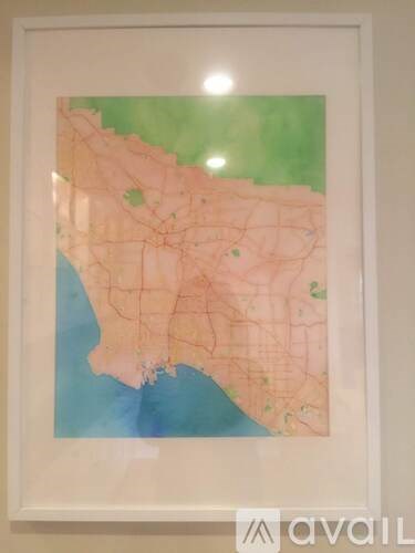 A framed map of a city with streets and green areas.