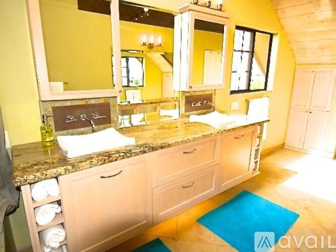 A kitchen with a granite countertop and white cabinets.