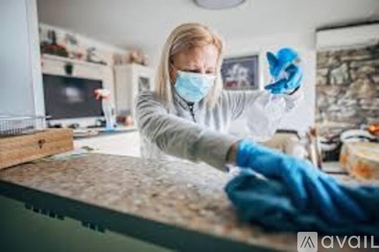 A person in protective gear is working on a countertop.