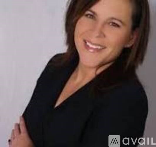 A woman with dark hair wearing a black top.