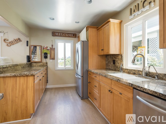 A kitchen with wooden cabinets and a refrigerator.
