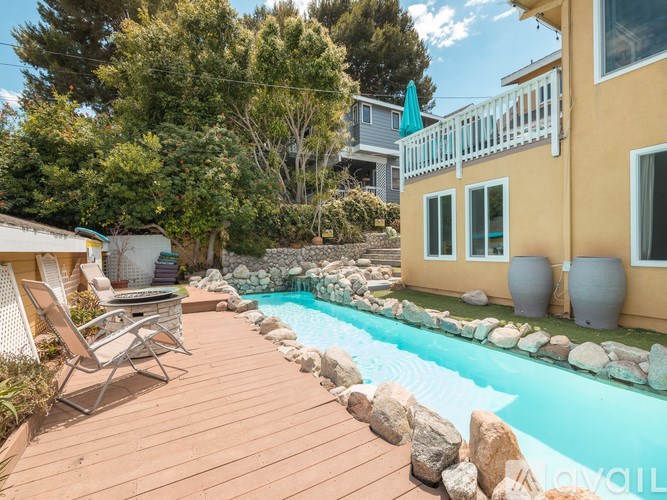 A backyard with a pool and deck.