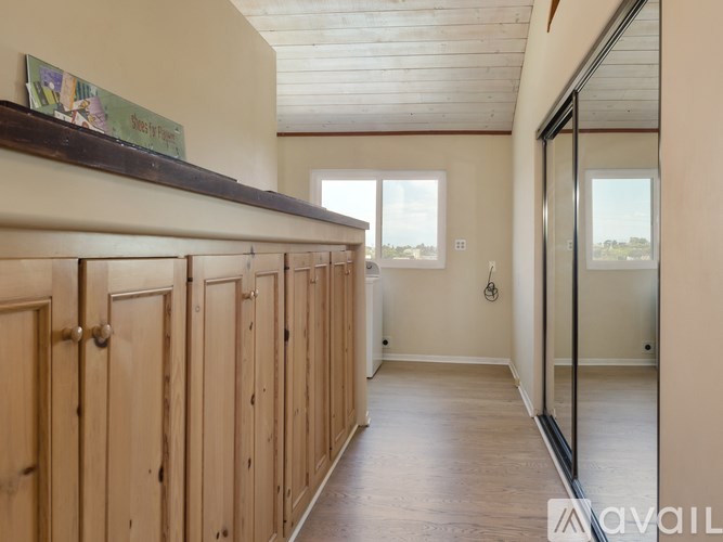 A row of wooden doors are lined up in a hallway.