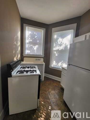 A kitchen with a stove top oven and a refrigerator.