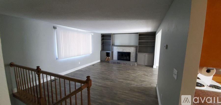 A living room with a fireplace and a balcony.