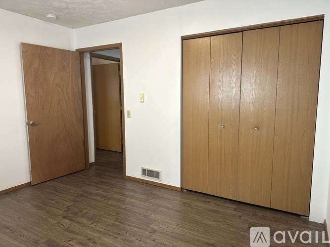 A room with a brown door and a brown wardrobe.