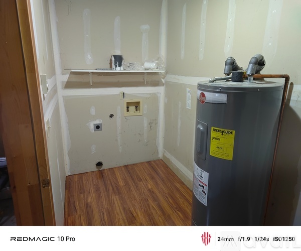 A kitchen with wooden cabinets and a white refrigerator.