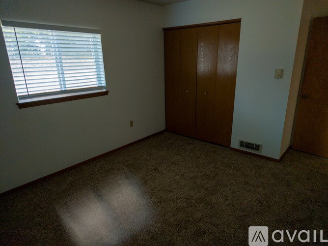 A bathroom with a toilet, sink, and mirror.
