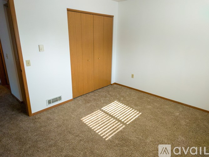 A kitchen with wooden cabinets and a white refrigerator.