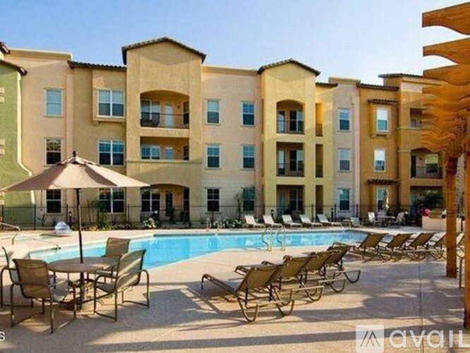 A large building with a pool in front of it.