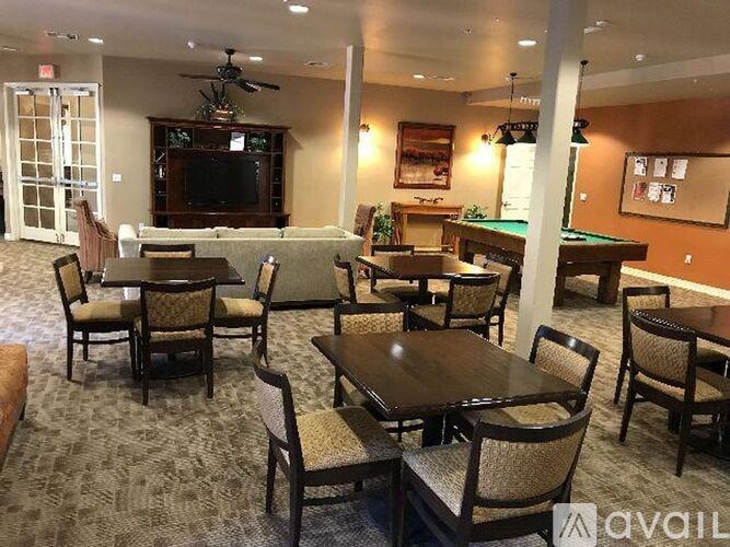 A room with a pool table and a television.