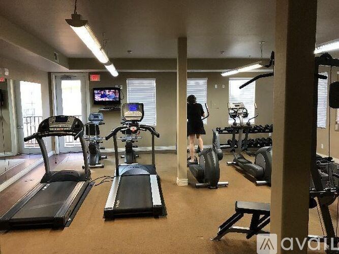 A woman is working out on a stationary bike in a gym.