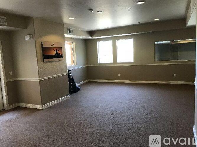 A room with a carpeted floor and a window.