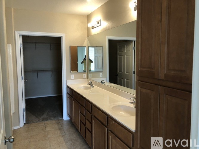 A bathroom with a sink, mirror, and medicine cabinet.