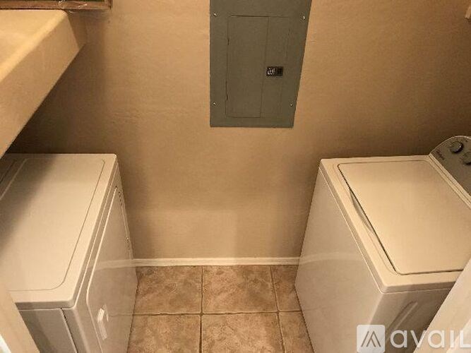 A small bathroom with a toilet and a washing machine.