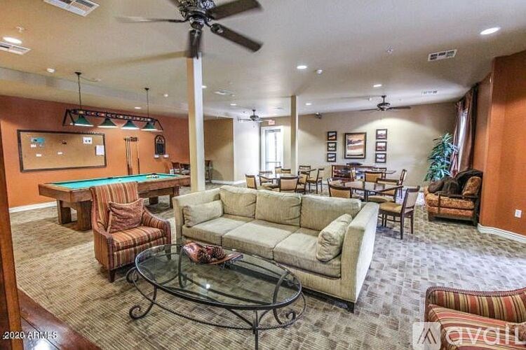 A living room with a glass coffee table and a couch.