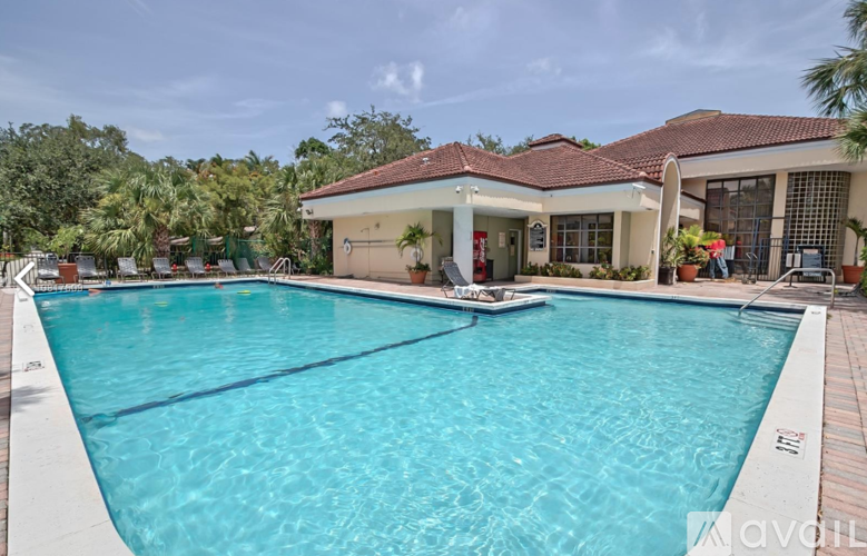 A large swimming pool in front of a house.