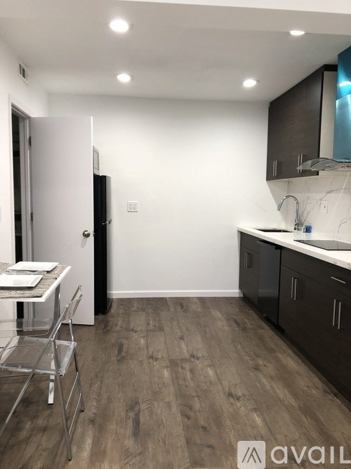 A kitchen with a dining table and chairs.