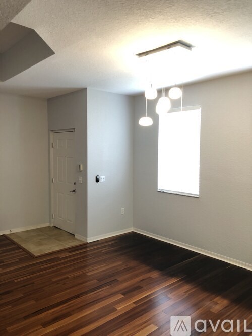 A room with wooden floors and a white door.
