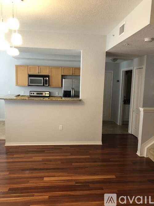 A kitchen with wooden floors and white walls.