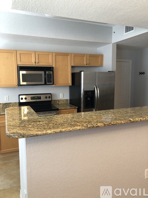 A kitchen with granite countertops and stainless steel appliances.