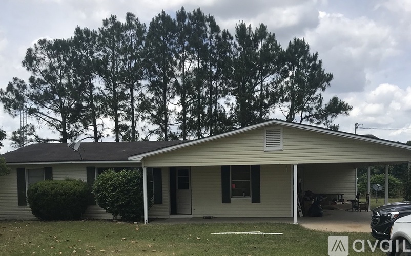 A house with a car parked in front of it.