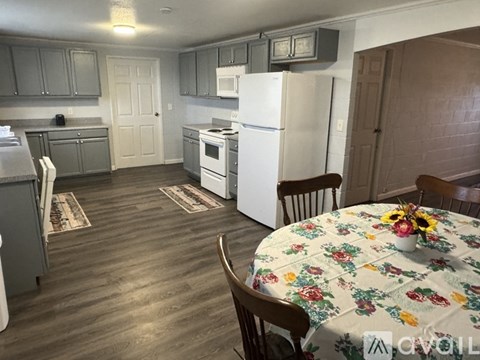 A kitchen with a table set for two.