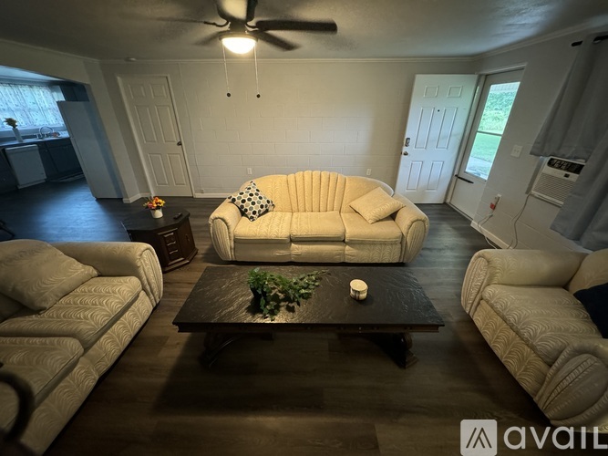 A living room with a large couch and a coffee table.