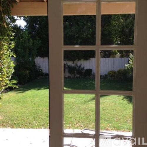 A white door with a glass window is open.