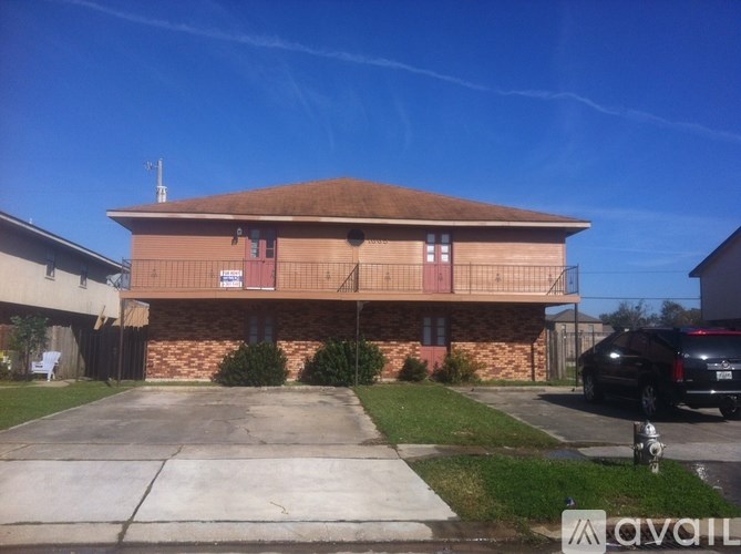 A building with a brown roof and a sign that says "AVAILABLE" in front of it.