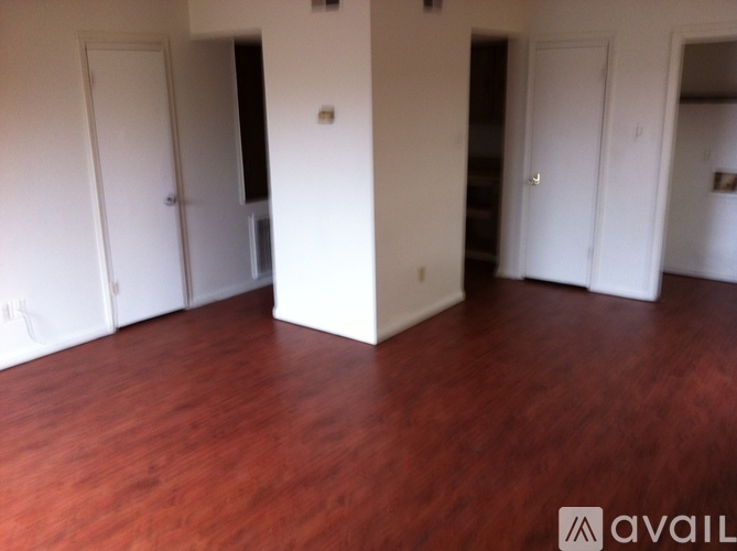 A room with wooden floors and white walls.