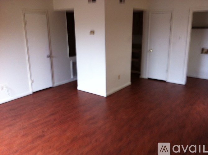 A room with wooden floors and white walls.