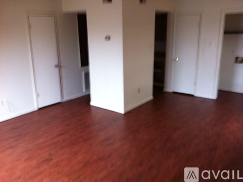 A room with wooden floors and white walls.