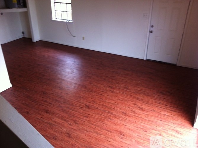 A room with a wooden floor and a white door.