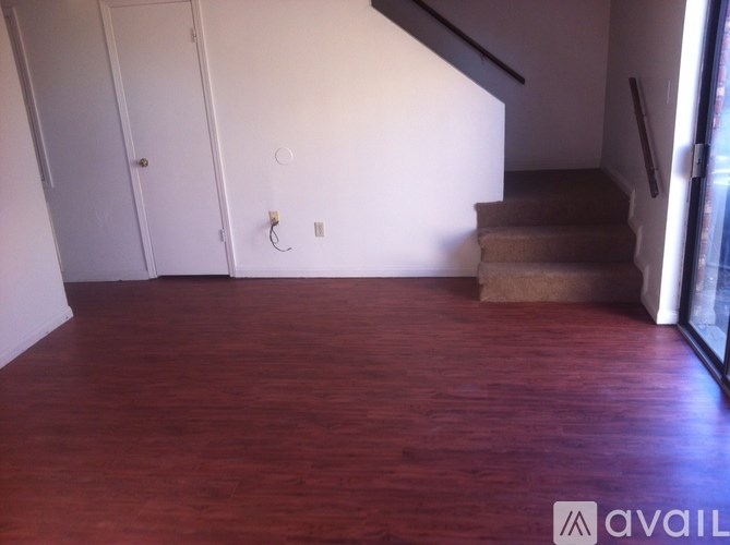 A room with wooden floors and a staircase.