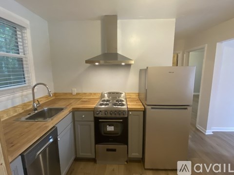 A kitchen with a stove, oven, and refrigerator.