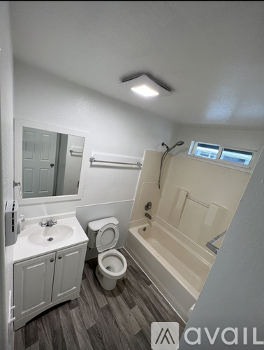 A bathroom with a toilet, sink, and bathtub.