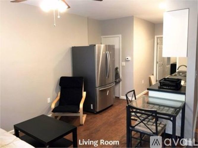 A living room with a black chair and a black table.