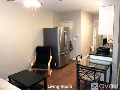 A living room with a black chair and a black table.