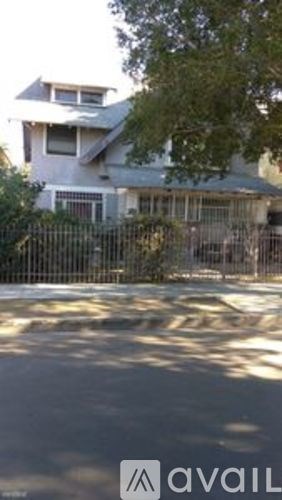 A house with a black fence in front of it.