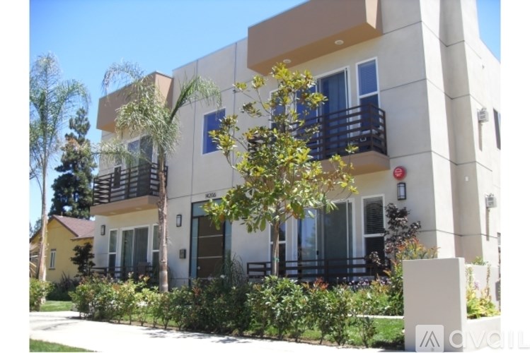 A modern two-story building with balconies and a balcony railing.