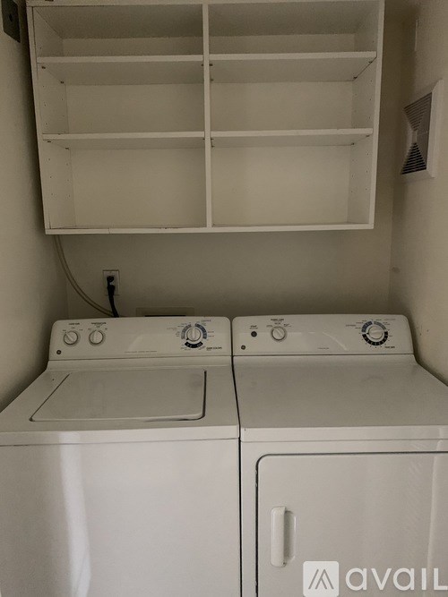 A washer and dryer are in a small laundry room.