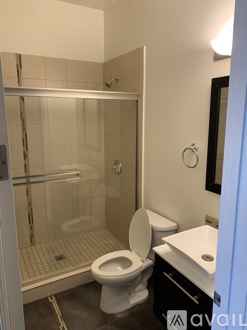A bathroom with a toilet, sink, and walk-in shower.
