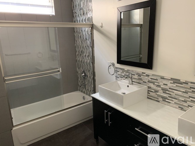 A white closet with a shelf and a white door.