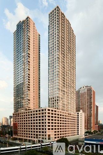 Two tall buildings are in the foreground with a third building in the background.